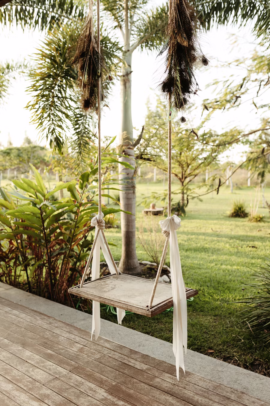 A wooden swing hanging in a green garden, an image of lightness returning in depression therapy
